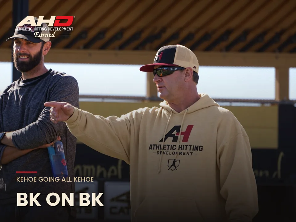BK, Coach Billy Kehoe, founder of Athletic Hitting Development, coaching on the field in an AHD hoodie