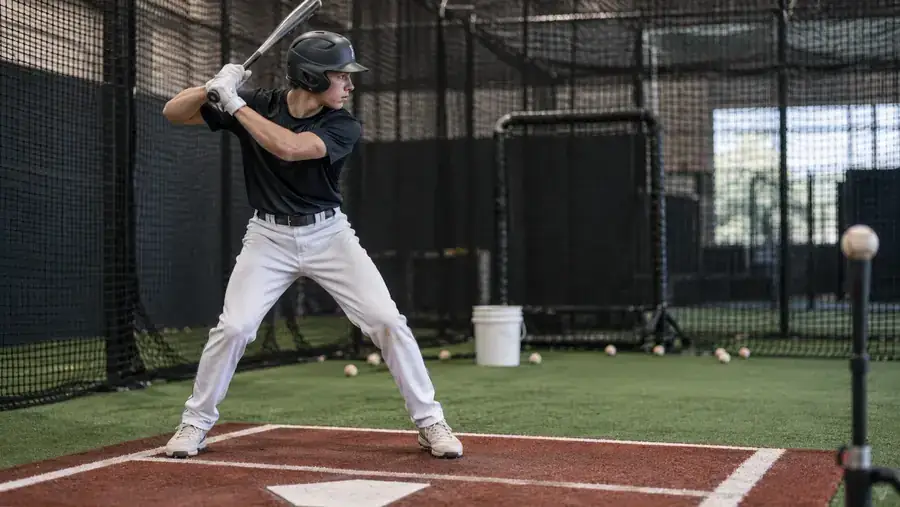 Baseball hitter training in a batting cage with Athletic Hitting Development