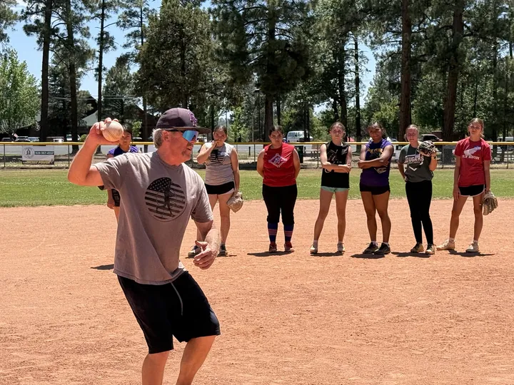 BK teaching throwing at a fastpitch camp