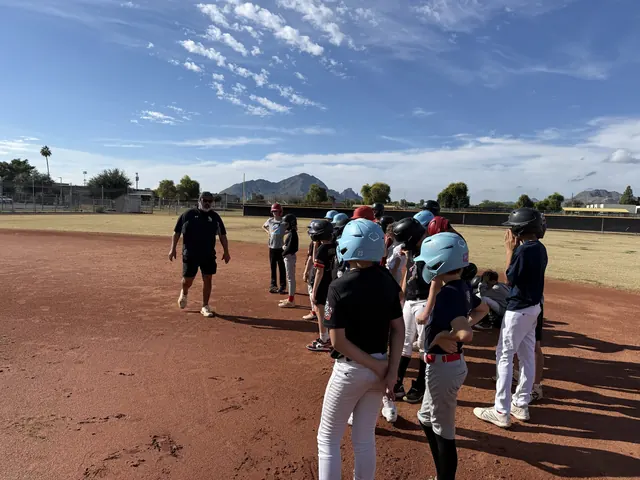 AHD camp players lined up on the infield in Scottsdale, Camelback Mountain behind them